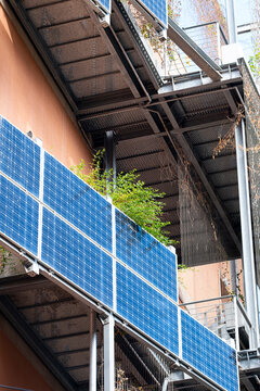 This captivating image highlights vertical solar panels integrated into a modern building's design, merging renewable energy solutions with contemporary architecture  in Barcelona Spain