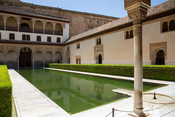 View of the Court of the Myrtles, with a large pool, located in the Comares Palace inside the Alhambra. It is one of the main monuments of Granada, Spain.