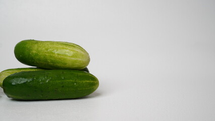 A bunch of fresh cucumbers isolated on a white background.