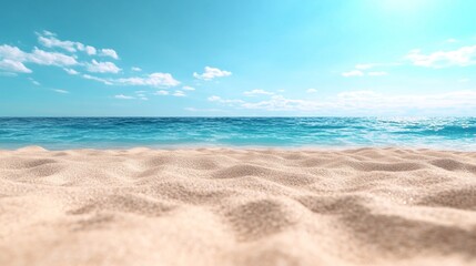 Sandy beach with gentle ocean waves under clear blue sky and fluffy white clouds in tranquil summer setting