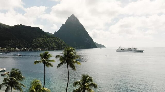 Soufriere Saint Lucia aerial shot of Petit Piton over the Caribbean Sea with boats on the water and palm trees
