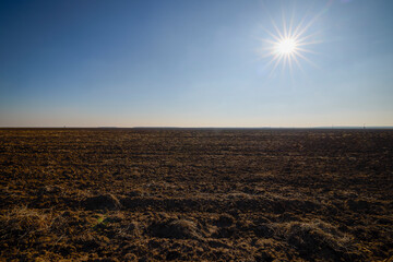 a plowed agricultural field during a sunny January day