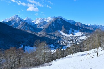 Fototapeta premium Winter view of Kranjska Gora town and snow covered mountains above in Gorenjska, Slovenia