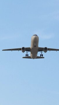 2160x3840 ULTRA HD. Airplane flies in blue sky. Travel. Airplane takes off against the background of blue Sky. 4K.