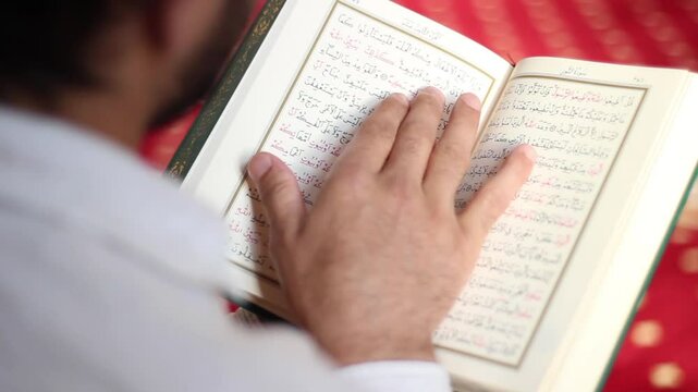 young muslim reading quran in mosque