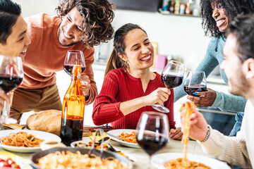 Happy friends toasting red wine glasses at dinner party - Group of people having lunch break at bar restaurant - Life style concept with guys and girls eating mediterranean food - Bright filter