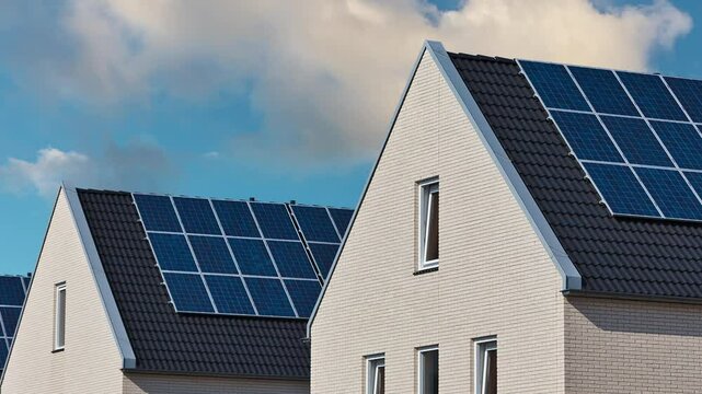 Horizontal pan of newly built Dutch houses with solar panels attached to the roof