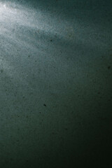A dark blue background with a light shining on it