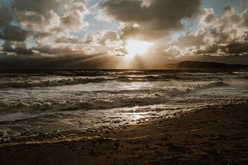 The sun is shining on the ocean, creating a beautiful and serene scene