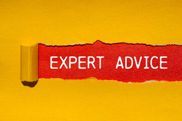 Expert advice message written on ripped torn yellow paper with red background. Conceptual expert advice symbol. Copy space.