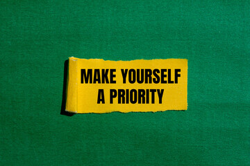 Make yourself a priority message written on ripped torn yellow paper piece with green background....