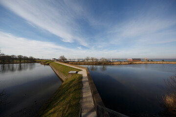 Waterway pathway under a bright sky in Willemstad showcasing natural beauty and serene atmosphere