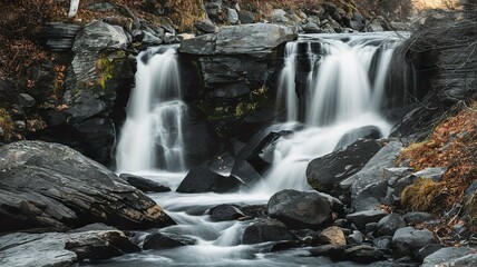 Obraz premium Downstream waterfall on black rocks during day