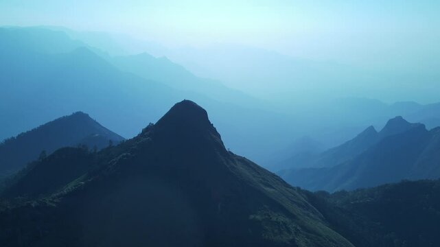 Aerial Drone Shot of Kolukkumalai Range at Sunrise, Overlooking the Lush Green Valleys Below
