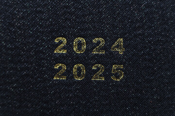 2025 text on black fabric background.