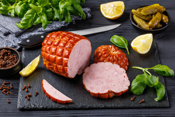 boneless smoked ham on black slate board, top view
