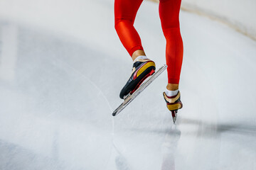 Naklejka premium legs male skater in red skin suit on ice background