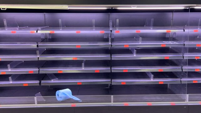 Completely empty fresh meat section shelves at a Mercadona grocery store in Marbella Malaga Spain, popular Spanish supermarket chain, 4K shot