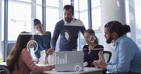 Image of data processing and diagrams over diverse colleagues discussing work in office