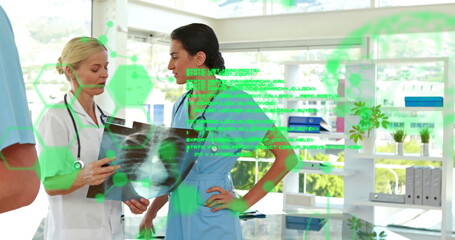 Image of data processing over diverse female doctors talking