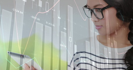 Image of financial data processing over asian businesswoman using tablet in office