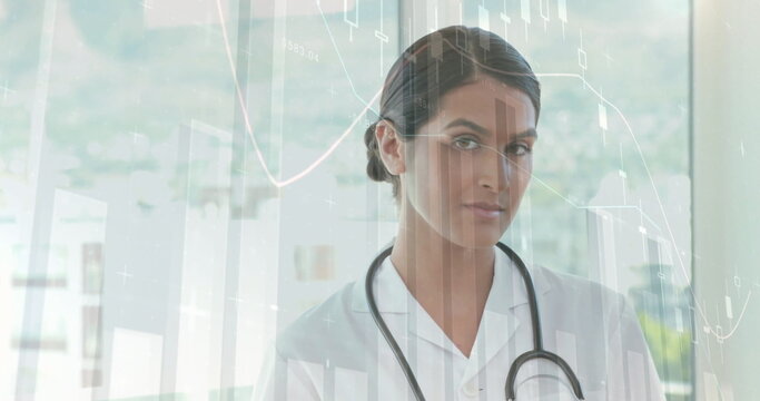 Image of financial data processing over caucasian female doctor using tablet