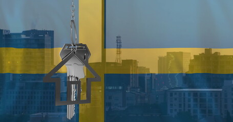 Image of silver house key over flag of sweden and cityscape