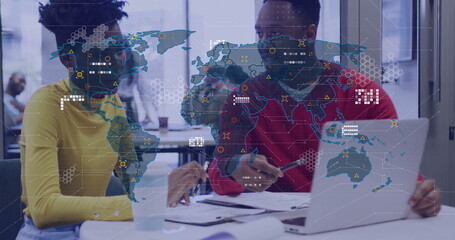 Image of world map with data processing over diverse colleagues using laptop in office