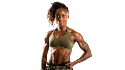 A confident woman with dreadlocks poses in a fitted green top and camouflage pants. Her strong physique highlights dedication to fitness and a disciplined lifestyle