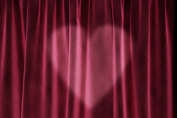 Valentine background with heart light on pink stage curtains. Velvet studio backdrop texture for birthday, wedding, mother's day and baby shower design.