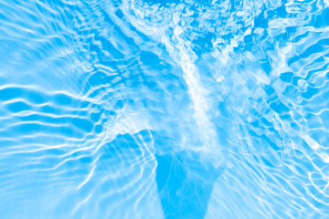 Bluewater waves on the surface ripples blurred. Defocus blurred transparent blue colored clear calm water surface texture with splash and bubbles. Water waves with shining pattern texture background.