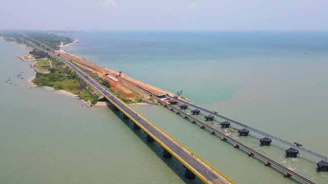 Breathtaking aerial drone shot of Rameshwaram city with a focus on the majestic bridge over the water.
