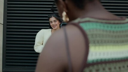 Over the shoulder shot of young woman sipping drink through straw posing for photo in front of dark background wall, while her friend capturing her on smartphone camera - Powered by Adobe