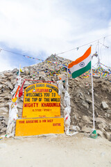 View of beautiful Himalayan mountains and tourist activities near the Monument of Khardungla at Khardungla Pass, Ladakh, in India.