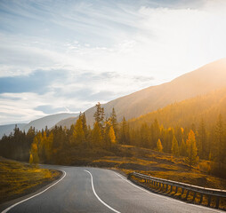 autumn mountain road at sunset
