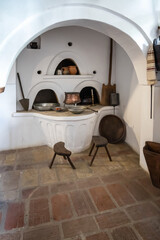Bulgarian Renaissance traditional home interior with fireplace and traditional tableware and furniture