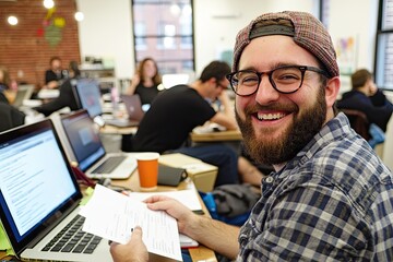 Fototapeta premium Startup founders celebrating success with laptops and documents in a cozy office environment