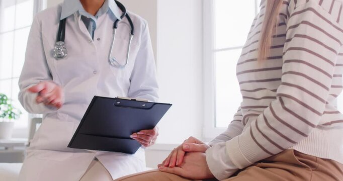 Doctor consulting woman patient close up at appointment in clinic, explaining medical checkup results, notes, serious physician giving recommendations at meeting, general practitioner, exam result