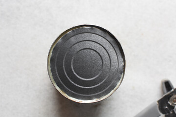 Overhead view of tin of canned food, top view of can being opened