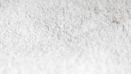 Fresh white towel in hotel room highlighting service and hygiene.