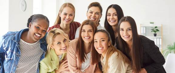 Portrait of a happy group of female colleagues or friends smiles in the office, showcasing...