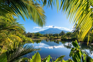 Obraz premium Serene tropical bay surrounded by palm trees with a distant mountain range, portraying natural harmony