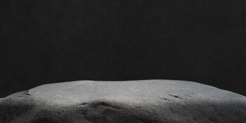 Close-up of a gray rock with soft shadows, perfect for refined backgrounds..