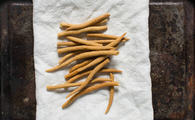 Top view of fried corn stick snack on a linen napkin, Overhead view of nigerian kokoro corn snack	