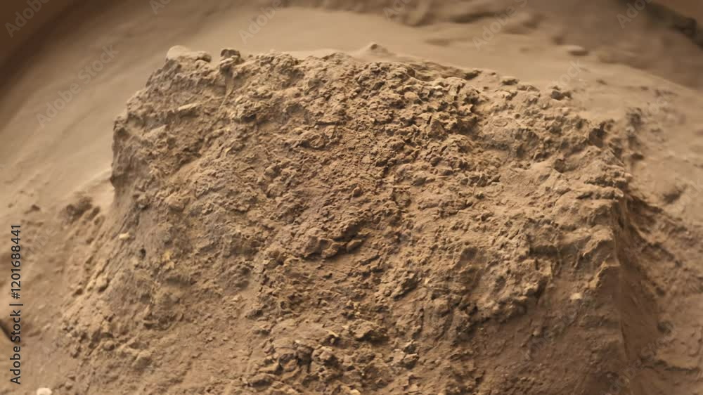 Poster camera rotates around a sample of clay soil after being worked by hand, the soft light highlights th