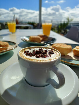 Cozy breakfast with cheese bread and a creamy latte, perfect for a sunny morning