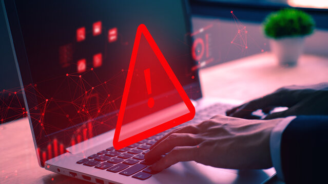 System hacked warning alert on notebook during cybersecurity risks in office environment focusing on digital security measures and threat awareness