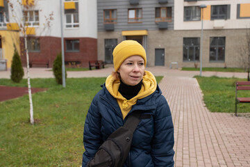 Portrait of a woman on a city street, adult walking outside in public, expression of casual mood...