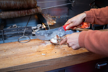 a cook prepares kokorec a traditional Turkish dish of intestines and offal mixed with giblets in bread