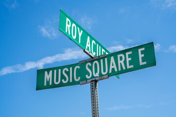 Signage marking the intersection of Roy Acuff and Music Square E in Nashville, Tennessee on a sunny day in the city